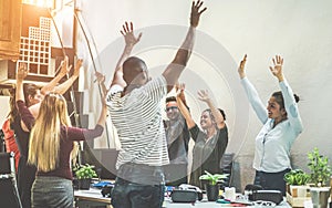 Teamwork in creative office with arms up for successful startup - Co-working, human resources and entrepreneur concept - Young photo