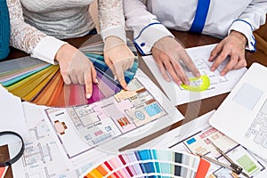 Teamwork of designers choosing colors for rooms in house