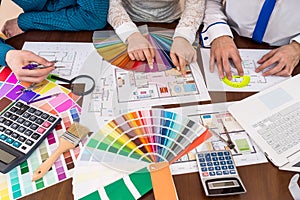 Teamwork of designers choosing colors for rooms photo