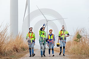 Teamwork engineer worker wearing safety uniform discuss operational planning at wind turbine field renewable energy. technology