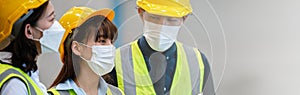 Teamwork engineering in uniform wear hardhat and protection mask at workshop industrial factory. worker professional manufacturing