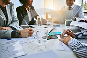 Teamwork is essential to the survival of any business. a group of businesspeople having a meeting in an office.