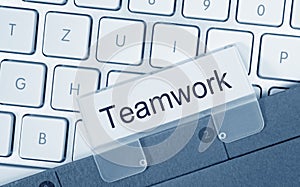 Teamwork - folder on computer keyboard