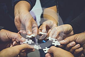 Teamwork group of hand holding jigsaw. business concept