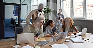 Teamwork. Group of young happy multicultural business people working together in modern office, communicating and