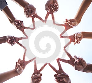 Teamwork, hands and star of peace at white background for support, partnership and collaboration from below. Closeup