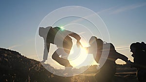 Teamwork help business three men hold hand travel silhouette concept. group of tourists lends a helping hand climb the