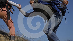 Teamwork help business travel concept couple man lifestyle and woman. Of tourists lends a helping hand climb the cliffs