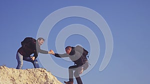 Teamwork help business travel silhouette concept lifestyle . group of tourists lends a helping hand climb the cliffs