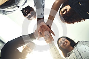 Teamwork is inevitable towards our success. Closeup shot of a group of businesspeople joining their hands together in a