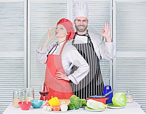 Teamwork in kitchen. Couple cooking dinner. Woman and bearded man culinary partners. Delicious family dinner. Reasons