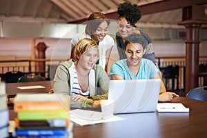 Teamwork, laptop or group of students studying in university, college or school campus for education. Library, elearning