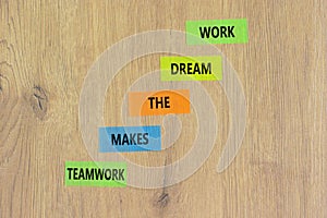 Teamwork makes the dream work symbol. Concept words Teamwork makes the dream work on color papers on a beautiful wooden background