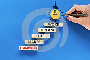 Teamwork makes dream work symbol. Concept words Teamwork makes the dream work on wooden blocks on a beautiful blue background.