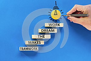 Teamwork makes dream work symbol. Concept words Teamwork makes the dream work on wooden blocks on a beautiful blue background.