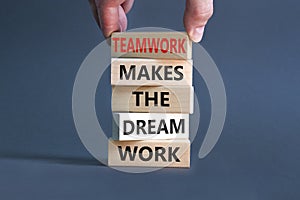 Teamwork makes dream work symbol. Concept words Teamwork makes the dream work on wooden blocks on a beautiful grey background.