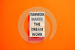 Teamwork makes the dream work symbol. Concept words Teamwork makes the dream work on wooden blocks on a beautiful orange table