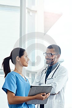 Teamwork makes the hospital work. two young doctors using a digital tablet in a modern hospital.