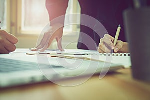 Teamwork, A man`s hand pointing to a graph of financial graphs to inform his colleagues of the numbers. photo