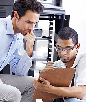 Teamwork, IT and men with clipboard in server room for maintenance, inspection and fixing. Checklist, network technician