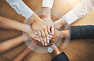 Teamwork is the most vital component to our success. Closeup shot of a group of businesspeople joining their hands