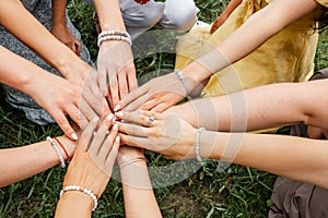 Teamwork. Multiracial group of friends with hands in stack.