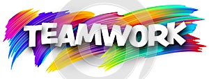 Teamwork paper word sign with colorful spectrum paint brush strokes over white