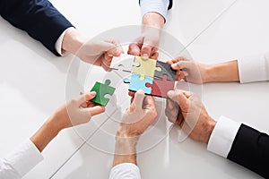 Teamwork of partners. Concept of integration and startup with puzzle pieces