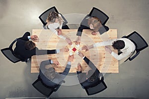 Teamwork of partners. Concept of integration and startup with puzzle pieces