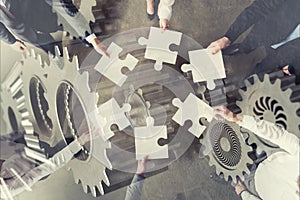 Teamwork of partners. Concept of integration and startup with puzzle pieces and gear overlay. double exposure