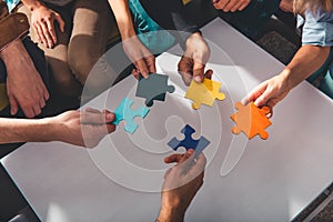 Teamwork of partners connect puzzle pieces as integration and startup