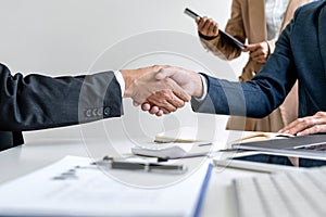 Teamwork partnership meeting concept, Two confident Business shaking hands after discussing good deal of trading contract and new