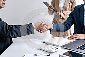 Teamwork partnership meeting concept, Two confident Business shaking hands after discussing good deal of trading contract and new