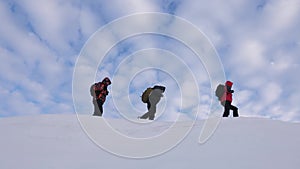 Teamwork people in difficult conditions. climbers team in winter go to top of the mountain. Travelers follow one another