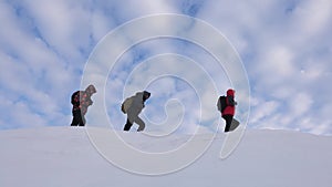 Teamwork people in difficult conditions. climbers team in winter go to top of the mountain. Travelers follow one another