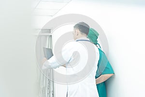 Teamwork of professional doctor men medical team consulting with x-ray film in hospital.Health care and teamwork  medical concept