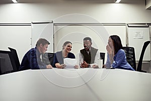 Teamwork is the quickest way to gain momentum towards success. a group of designers having a meeting in an office.