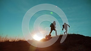Teamwork run jump throw backpacks happiness joy victory success. Two hikers enjoying sunrise walking from top of a