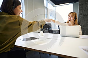 Teamwork of saleswomen in e-commerce call center photo