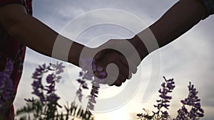 Teamwork. Shaking hands of two people-a close-up. Male allies shake hands, success at work, a deal.