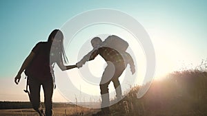 Teamwork Silhouette of helping hand hikers help business travel silhouette concept. happy family couple group of