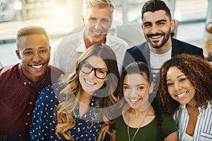 Teamwork, smiling and diverse workers standing together in a creative workplace. Portrait of group of casual