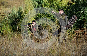 Teamwork and support. Activity for real men concept. Hunters gamekeepers looking for animal or bird. Hunting with