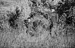 Teamwork and support. Activity for real men concept. Hunters gamekeepers looking for animal or bird. Hunting with