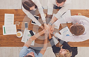 Teamwork and teambuilding concept in office, people connect hand