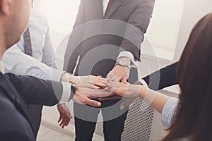 Teamwork and teambuilding concept in office, people connect hand, closeup