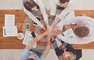 Teamwork and teambuilding concept in office, people connect hand photo