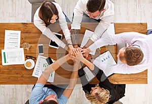 Teamwork and teambuilding concept in office, people connect hand