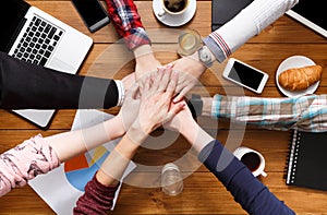 Teamwork and teambuilding concept in office, people connect hands