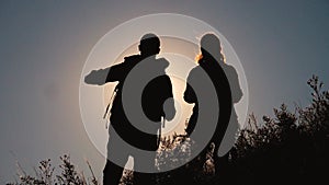 Teamwork tourists travel concept slow motion video. hiking silhouette happy family couple man and girl go hiking